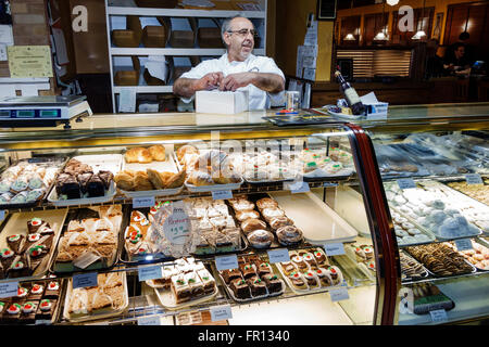 Florida New Port Richey,Argento's Italian Bistro & Pastry Shop,desserts,sweets,sale,display sale pastries,baker,adult,adults,man men male,working work Stock Photo