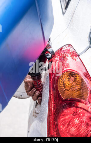 Emergency vehicle refueling, pouring fuel into gas tank from gas canister. Stock Photo