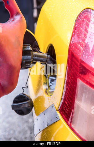 Emergency vehicle refueling, pouring fuel into gas tank from gas canister. Stock Photo