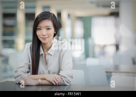 Portrait confident businesswoman at table Stock Photo