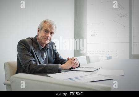 Portrait confident senior businessman working in conference room Stock Photo