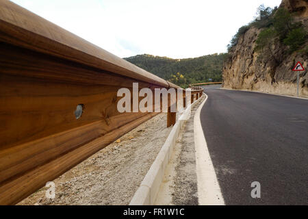 Wooden crash barrier on road side, Natural park of Ardales and El Chorro, mountain range, Andalusia, Spain. Stock Photo