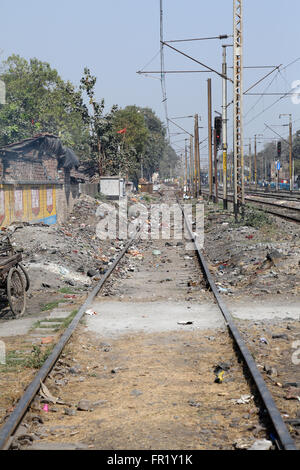 Trains passing through the slums where people live in difficult conditions on February 09, 2014 in Titagarh, West Bengal, India. Stock Photo