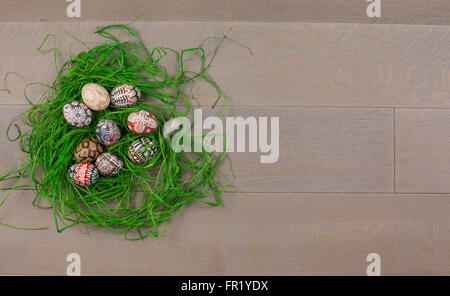 Easter eggs in nest on wooden background (space for text) Stock Photo
