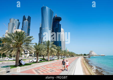 View along waterfront of Corniche towards modern office towers in West Bay financial and business district in Doha Qatar Stock Photo