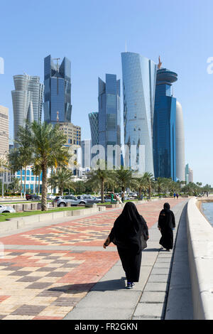 View along waterfront of Corniche towards modern office towers in West Bay financial and business district in Doha Qatar Stock Photo