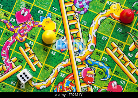 Close up detail of wooden snakes & ladders game those were the days - satisfaction guaranteed by Prof Warbles high quality Stock Photo