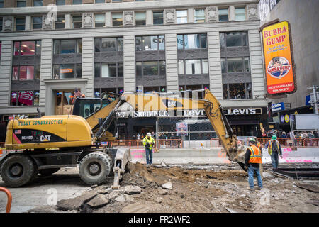 Caterpillar brand construction equipment in Times Square in New York on Friday, March 18, 2016 . Caterpillar Inc., which makes earth-moving equipment, diesel engines and gas turbines, announced the forecast for its first-quarter profits, ending March 31, would be below analysts' expectations. (© Richard B. Levine) Stock Photo