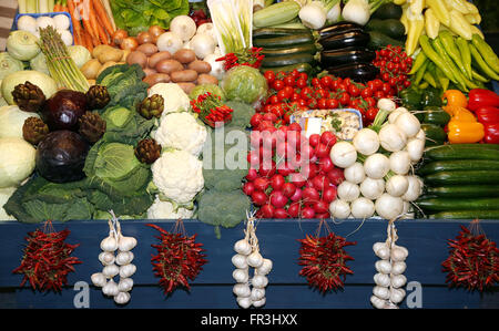 Close up of many colorful vegetables on market stand. Big assortment of organic vegetables on market Stock Photo