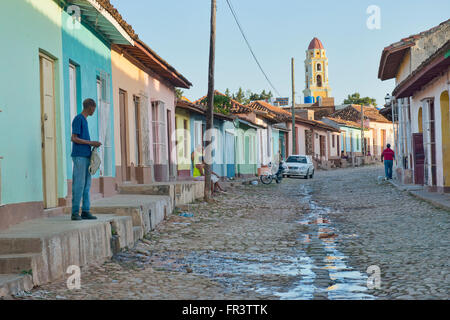 A street in the old colonial town of Trinidad, Cuba with the Iglesia y Convento de San Francisco in the background. Stock Photo