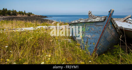 old wrecked boat on grassy coastline in prince edward island canada Stock Photo