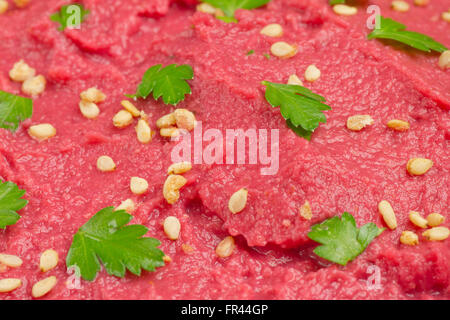 Close up of a beet hummus with sesame and coriander Stock Photo