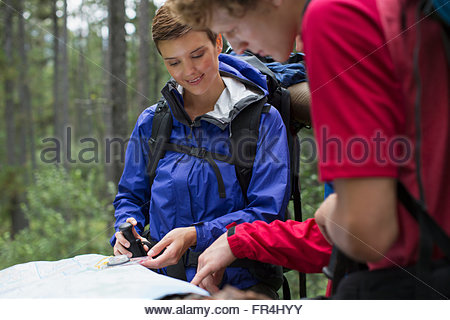 male and female backpackers reviewing trail map