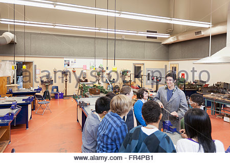 teacher demonstrating to machine shop class