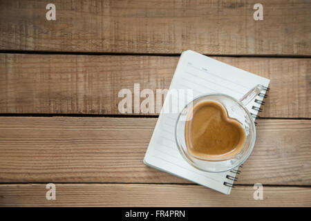 Heart shape coffee cup on wooden table-Selective focus point Stock Photo