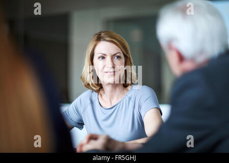 Businesswoman listening to businessman in meeting Stock Photo