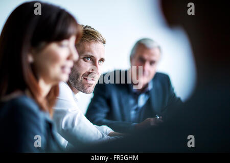 Businessman listening in meeting Stock Photo