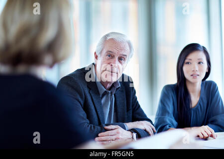 Senior businessman listening in meeting Stock Photo