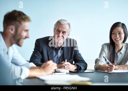 Portrait smiling senior businessman in meeting Stock Photo