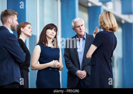 Business people talking in lobby Stock Photo