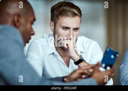 Serious businessmen examining part Stock Photo