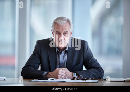 Portrait serious senior businessman in conference room Stock Photo
