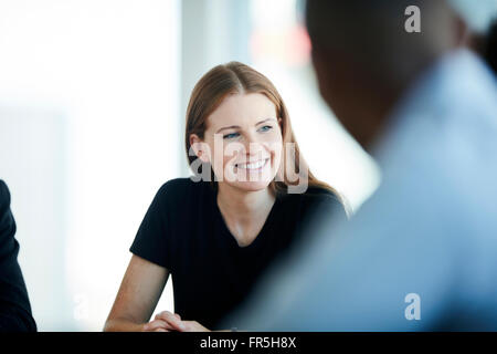 Smiling businesswoman in meeting Stock Photo