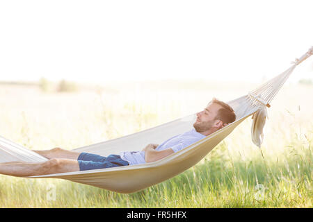 Young man sleeping in summer hammock Stock Photo