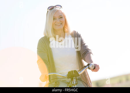 Portrait smiling senior woman bike riding Stock Photo
