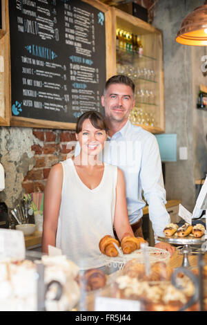 Portrait smiling cafe owner couple behind the counter Stock Photo