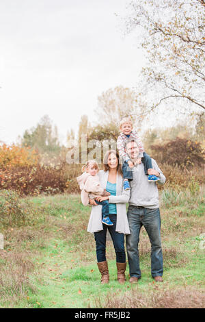 Portrait smiling family in autumn park Stock Photo