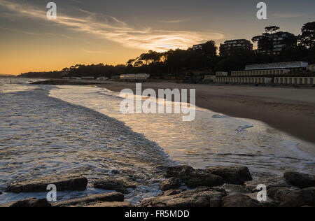 Sunset over Poole Bay coastline at Canford Cliffs and Sandbanks, Dorset, England, UK Stock Photo