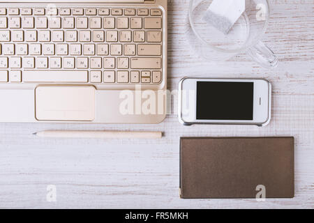 Laptop, mobile phone, notebook on a wooden table horizontal Stock Photo