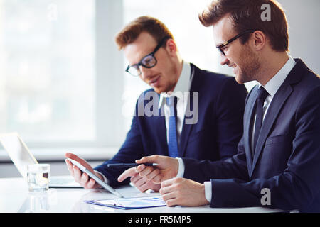 Two businessmen discussing at the table together Stock Photo