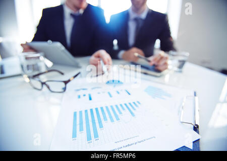 Business partners discussing financial documents at office Stock Photo