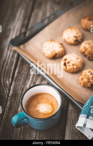 Oatmeal cookies and coffee cup on a wooden table vertical Stock Photo