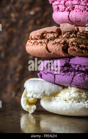 Pyramid of broken macaroon on a metal background vertical Stock Photo