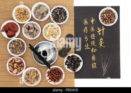 Chinese medicinal herb ingredients, acupuncture needles, moxa sticks and i ching coins, with calligraphy on old grey paper. Stock Photo