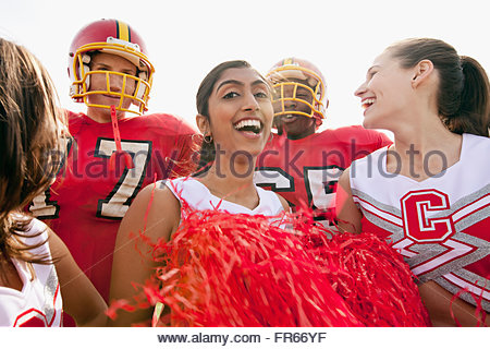 college football players with cheerleaders Stock Photo - Alamy