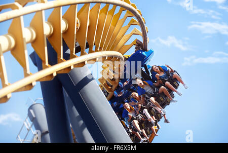 People riding amusement park ride Stock Photo