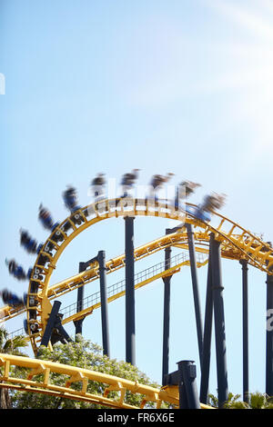 People flipping upside-down on amusement park ride Stock Photo