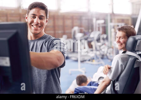 Physical therapist at computer talking to man Stock Photo