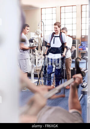 Man with forearm crutches receiving physical therapy Stock Photo