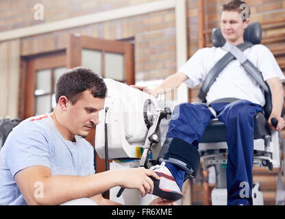 Physical therapy checking man’s foot Stock Photo