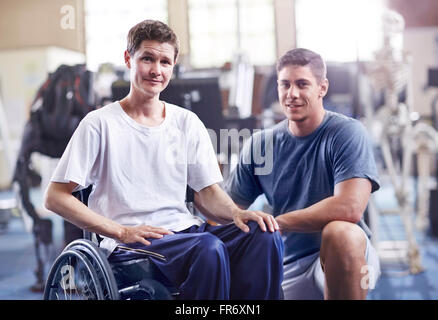 Portrait confident physical therapist and man in wheelchair Stock Photo