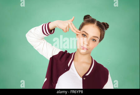 bored student girl making finger gun gesture Stock Photo