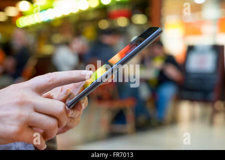 Woman using cell phone in mall. App, texting, sms, message, mail Stock Photo