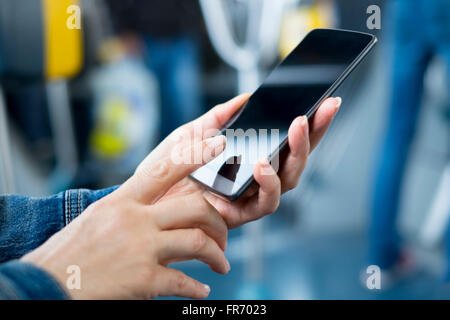 Woman using smartphone on bus. Sms, message, app Stock Photo