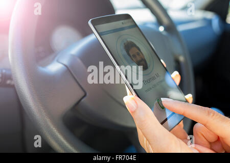 In the car Woman answering mobile phone, calling a friend Stock Photo