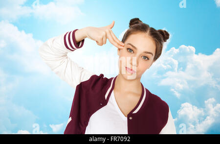 bored teenage girl making finger gun gesture Stock Photo